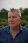 An author photograph of Michael Brissenden, who is looking off-camera