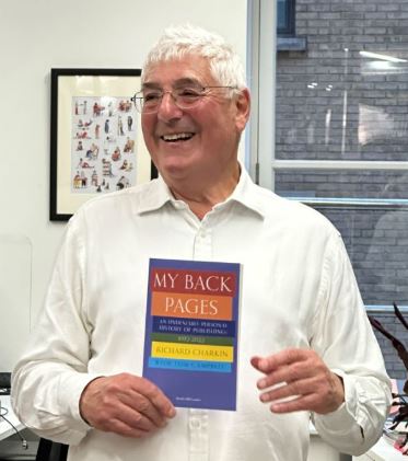 Photograph of Richard Charkin holding his book My Back Pages