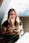 Photograph of Brittany Schulz holding a book