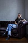 Photograph of Alexandra Christie sitting on a sofa