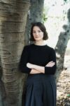 Photograph of Amy Taylor standing in front of a tree